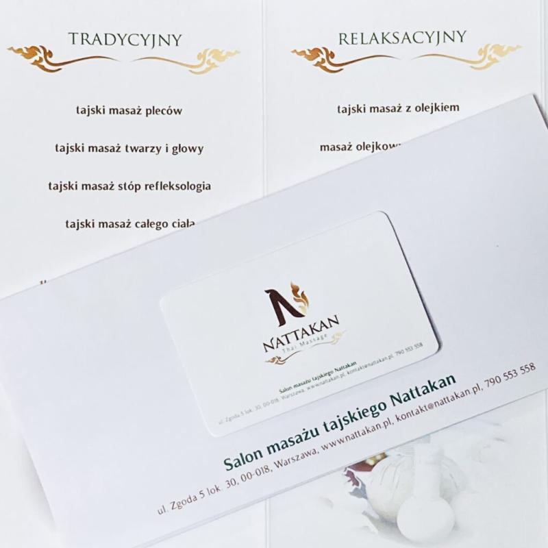 Image showing a brochure and business card for Nattakan Thai Massage salon. The brochure lists various types of massage services under categories Tradycyjny (Traditional) and Relaksacyjny (Relaxation) in Polish, offering services such as Thai back massage, face and head massage, foot reflexology, whole body massage, oil massage, and oil therapy massage. The business card contains the Nattakan Thai Massage logo and contact details, including the salons address, website, and phone number. Image displaying Nattakan Thai Massage materials, including a business card and a brochure. The brochure lists various traditional and relaxation Thai massage services, such as back massage, face and head massage, reflexology foot massage, full body massage, oil massage, and aromatherapy massage. The business card and brochure include the salons contact information and website.